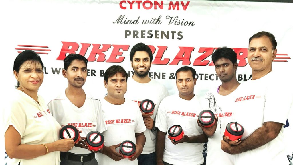 BikeBlazer team members holding the semi automatic portable bike cover device during the product launch