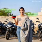 Woman holding the BikeBlazer semi automatic folding bike cover device and a traditional bike cover for comparison
